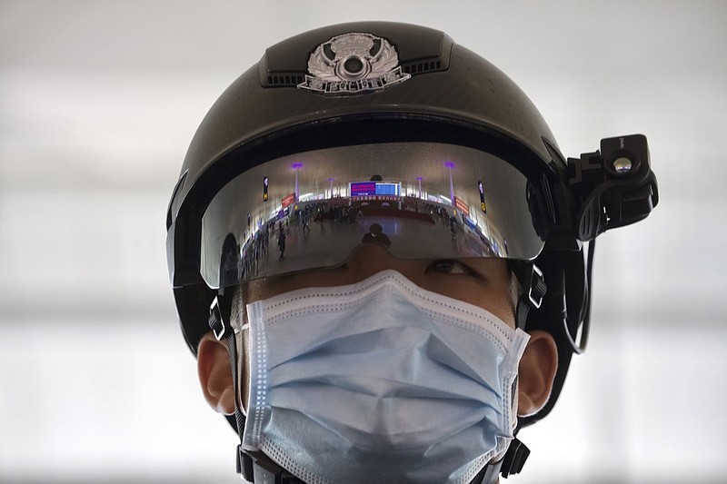 A police officer wearing a face mask to protect against the spread of new coronavirus stands guard at Wuhan Tianhe International Airport in Wuhan in central China's Hubei Province, Wednesday, April 8, 2020. Within hours of China lifting an 11-week lockdown on the central city of Wuhan early Wednesday, tens of thousands people had left the city by train and plane alone, according to local media reports. (AP Photo/Ng Han Guan)
