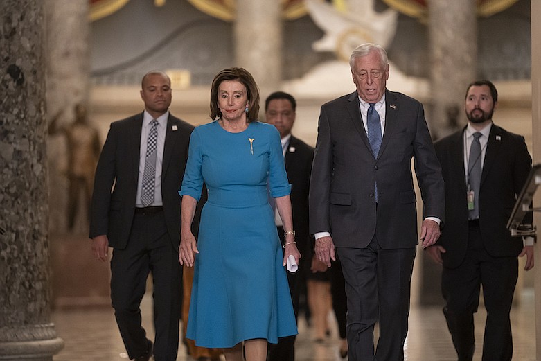 In this March 13, 2020, file photo Speaker of the House Nancy Pelosi, D-Calif., and Majority Leader Steny Hoyer, D-Md., arrive to make a statement ahead of a planned late-night vote on the coronavirus aid package deal, at the Capitol in Washington. Democrats are wrestling over how best to assail Trump for his handling of the coronavirus pandemic and the economy's shutdown even as the country enters an unpredictable campaign season against the backdrop of the most devastating crisis in decades. (AP Photo/J. Scott Applewhite, File)