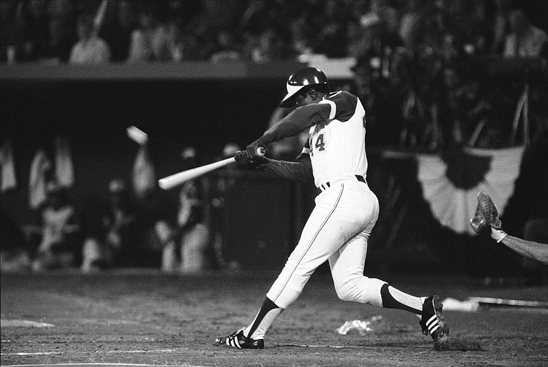 Atlanta Braves' Hank Aaron hits his 715th career home run in Atlanta Stadium, April 8, 1974, to break the all-time record set by the late Babe Ruth. The ball is a blur as it leaves the bat. (AP Photo/Joe Holloway, Jr.)