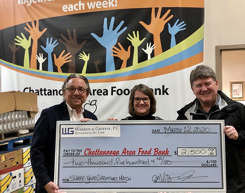 Contributed photo / C. Mark Warren, left, and John Mark Griffin, right, chief executive officers of the law firm Warren & Griffin, P.C., present a donation to Shelley Armstrong, director of events and major gifts at the Chattanooga Area Food Bank.