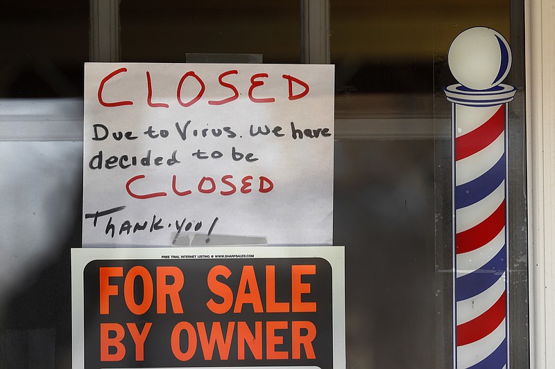 "For Sale By Owner" and "Closed Due to Virus" signs are displayed in the window of Images On Mack in Grosse Pointe Woods, Mich., Thursday, April 2, 2020. The coronavirus outbreak has triggered a stunning collapse in the U.S. workforce with 10 million people losing their jobs in the past two weeks and economists warn unemployment could reach levels not seen since the Depression, as the economic damage from the crisis piles up around the world. (AP Photo/Paul Sancya)


