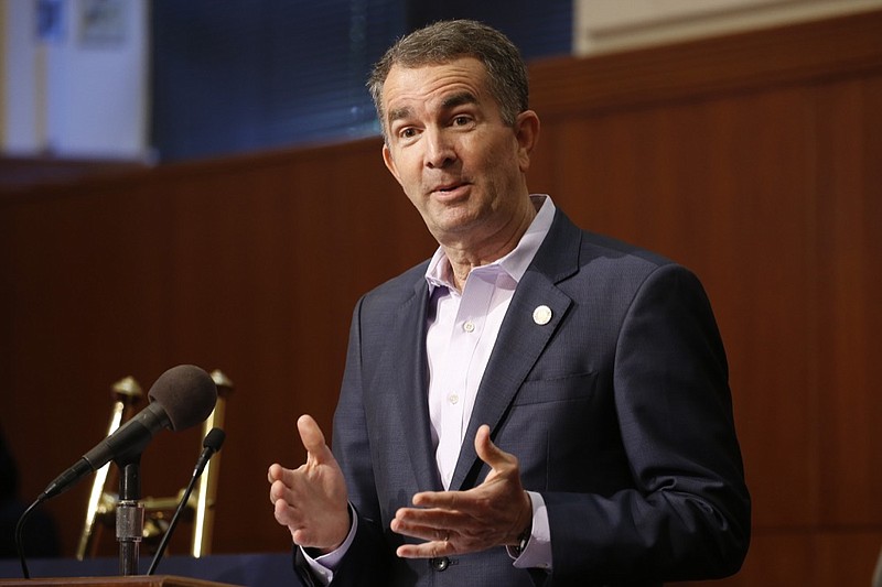Virginia Gov. Ralph Northam gestures during a news conference at the Capitol Wednesday April 8, 2020, in Richmond, Va. Northam gave an update on his COVID-19 plans. (AP Photo/Steve Helber)
