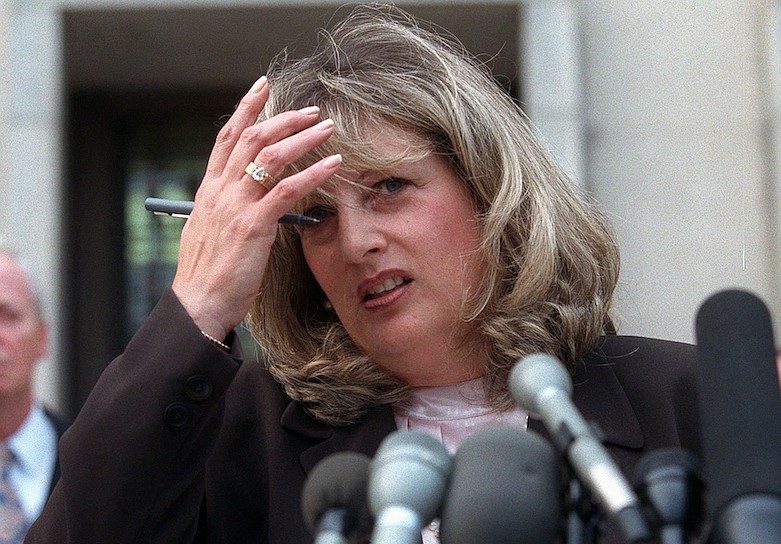 In this July 29, 1998 file photo Linda Tripp talks to reporters outside federal court in Washington. Tripp, whose secretly recorded conversations with White House intern Monica Lewinsky led to the 1998 impeachment of President Bill Clinton, died Wednesday, April 8, 2020, at age 70. (AP Photo/Khue Bui, File)
