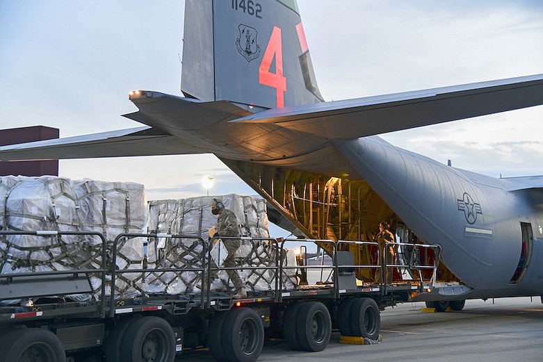 In this Tuesday, April 7, 2020 photo provided by the U.S. Air National Guard, airmen from the 146th Airlift Wing of the California Air National Guard in Oxnard, Calif., deliver 200 ventilators to the New York Air National Guard's 105th Airlift wing at Stewart Air National Guard Base, adjacent to Newburgh, N.Y. (Senior Airman Jonathan Lane/U.S. Air National Guard via AP)