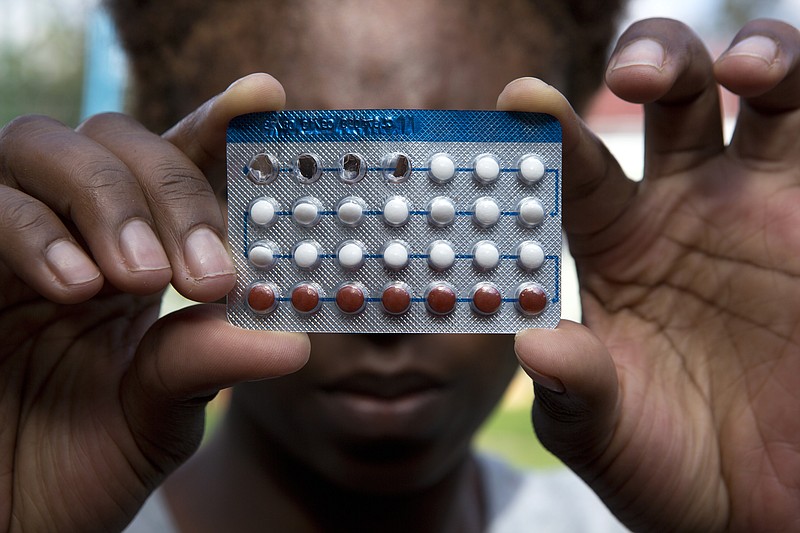 A woman holds a packet of contraceptive pills, in Harare, Thursday, April 9, 2020. Lockdowns imposed to curb the coronavirus' spread have put millions of women in Africa, Asia and elsewhere out of reach of birth control and other sexual and reproductive health needs. Confined to their homes with husbands and others, they face unwanted pregnancies and little idea of when they can reach the outside world again. (AP Photo/Tsvangirayi Mukwazhi)


