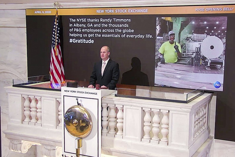 In this photo taken from video provided by the New York Stock Exchange, Chief Security Officer Kevin Fitzgibbons rings the opening bell at the NYSE, while recognizing Randy Timmons in Albany, Ga., and thousands of employees of the Proctor & Gamble Company, Thursday, April 9, 2020. (New York Stock Exchange via AP)


