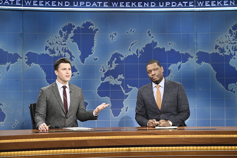 This Feb. 29, 2020 photo released by NBC shows Colin Jost, left, and Michael Che during the Weekend Update sketch on "Saturday Night Live" in New York. The show will be back on the air this weekend with a show that abides by social distancing rules. NBC says the comedy sketch show will include include a "Weekend Update" news segment and original content from "SNL" cast members. The material will be produced remotely, in compliance with efforts to limit the spread of the coronavirus. (Will Heath/NBC via AP)

