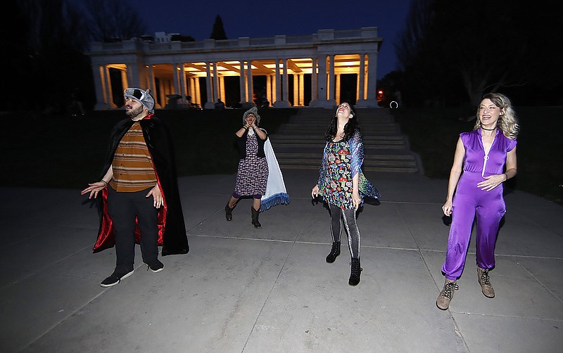 In this Wednesday, April 8, 2020, photograph, Brice Maiurro, Shelsea Ochoa, Anna Beazer and Kali Healf, from left, howl in Cheesman Park in Denver, during. the coronavirus outbreak. From California to New York, some Americans are taking a moment each night at 8 o'clock to howl as a way of thanking the health care workers and first responders who are fighting the coronavirus pandemic. (AP Photo/David Zalubowski)


