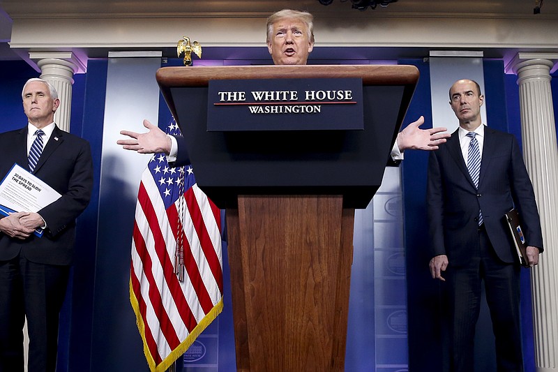 President Donald Trump, accompanied by Vice President Mike Pence, left, and Labor Secretary Eugene Scalia, right, speaks about the coronavirus in the James Brady Press Briefing Room of the White House, Thursday, April 9, 2020, in Washington. (AP Photo/Alex Brandon)
