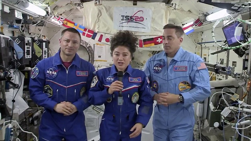In this image from video made available by NASA, U.S. astronaut Jessica Meir speaks, accompanied by Andrew Morgan and Chris Cassidy, during a news conference held by the American members of the International Space Station on Friday, April 10, 2020. Meir and Morgan said they expect it will be tough returning to such a drastically changed world next week, after a half-year or more in space. (NASA via AP)


