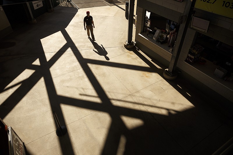 Staff photo / A fan walks past food vendors at the Chattanooga Lookouts' home opener against the Jackson Generals on April 12, 2016, at AT&T Field.