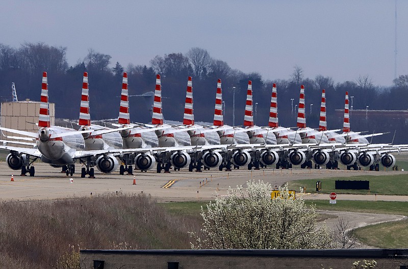 American Airlines planes stored at Pittsburgh International Airport sit idle on a closed taxiway in Imperial, Pa., on Tuesday, March 31, 2020. As airlines cut more service, due to the COVID-19 pandemic, Pittsburgh International Airport has closed one of its four runways to shelter in place 96 planes, mostly from American Airlines, as of Monday, March 30, 2020. The airport has the capacity to store 140 planes. (AP Photo/Gene J. Puskar)


