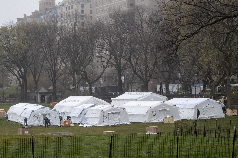 A Samaritan's Purse crew works on building an emergency field hospital specially equipped with a respiratory unit in New York's Central Park across from The Mount Sinai Hospital, Sunday, March 29, 2020. (AP Photo/Mary Altaffer, File)


