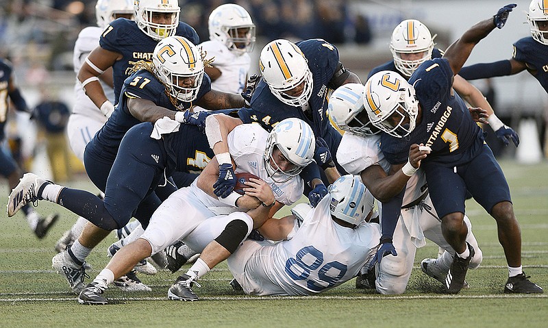 Staff photo by Robin Rudd / UTC's defense swarms The Citadel quarterback Brandon Rainey during a SoCon matchup in November 2019 at Finley Stadium. The Mocs and the Bulldogs would feel the bite of losing the gate from football games much more than Power Five schools if the COVID-19 pandemic persists.