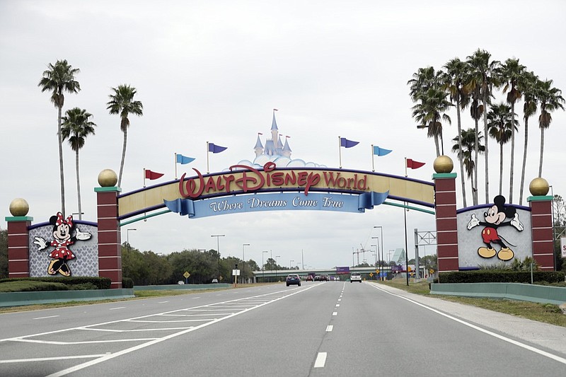 AP photo by John Raoux / The road to the entrance of Walt Disney World has few cars on March 16 in Lake Buena Vista, Fla.