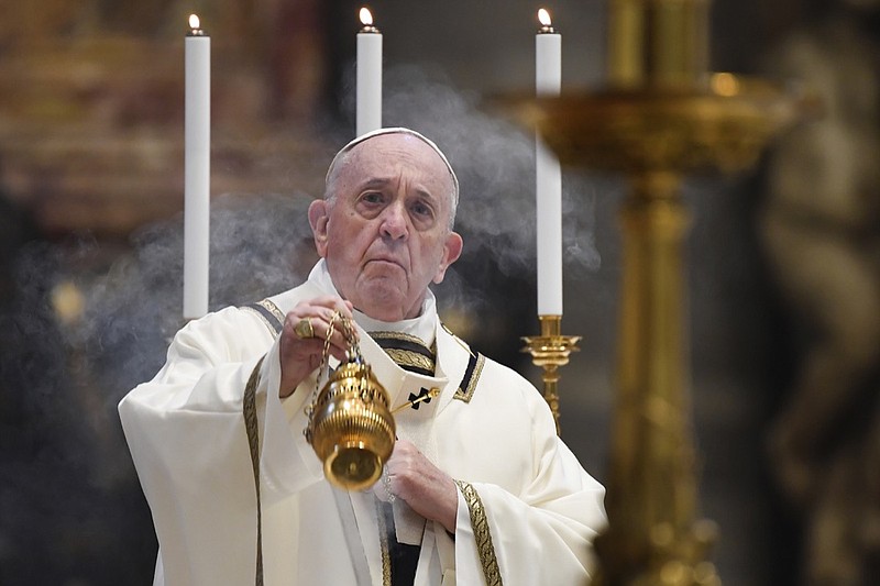 Pope Francis spreads incense at the start of Easter Sunday Mass, inside an empty St. Peter's Basilica at the Vatican, Sunday, April 12, 2020. Pope Francis and Christians around the world marked a solitary Easter Sunday, forced to celebrate the most joyful day in the liturgical calendar amid the sorrowful reminders of the devastation wrought by the coronavirus pandemic. The new coronavirus causes mild or moderate symptoms for most people, but for some, especially older adults and people with existing health problems, it can cause more severe illness or death. (Andreas Solaro/Pool via AP)