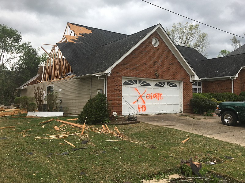 Staff photo by Mary Fortune / Extensive storm damage to neighborhoods along Shallowford Road, including Ashwood, Drake Forest and Ashwood Villages, left residents without power and with a massive clean-up effort to tackle Monday.
