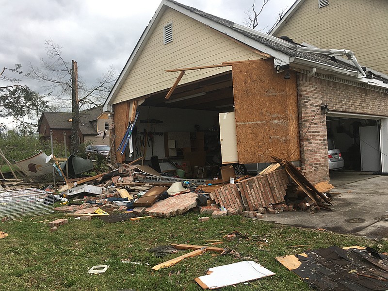 Staff photo by Mary Fortune / Extensive storm damage to neighborhoods along Shallowford Road, including Ashwood, Drake Forest and Ashwood Villages, left residents without power and with a massive clean-up effort to tackle Monday.