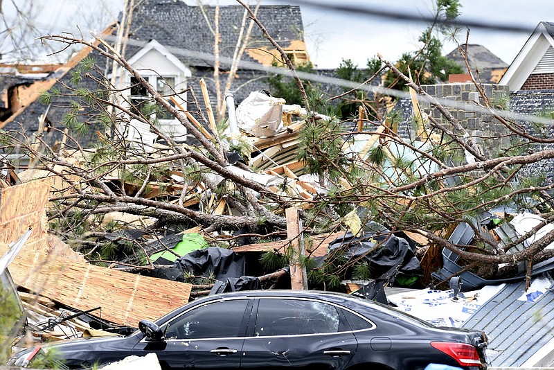 Staff Photo by Robin Rudd / A damaged car and mounts of debris are seen in the Legends neighborhood off Igou Gap Road in East Brainerd on April 13, 2020. The Chattanooga Area was hit by EF 3 tornado on the night of April 12, 2020.