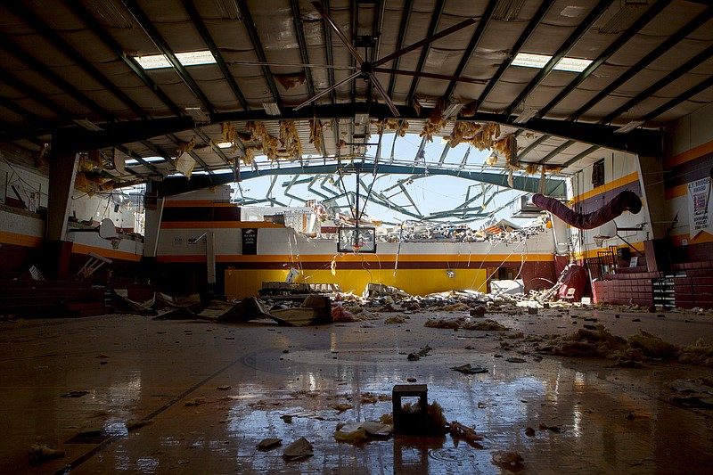 Staff photo by C.B. Schmelter / The roof is seen missing as debris covers the gym floor at Grace Baptist Academy on Tuesday, April 14, 2020 in Chattanooga, Tenn. The school was destroyed when an EF-3 tornado tore through Chattanooga.