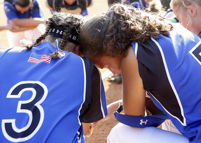 Staff photo by C.B. Schmelter / Sale Creek's Allison Smith (3) and Shelby Sullivan (5) pray with their teammates before a Class A state softball sectional game against Cosby at Sale Creek Middle/High School on Friday, May 17, 2019 in Sale Creek, Tenn.