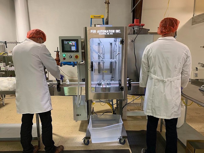 Kat's Naturals' COO Brian Merryfield, right, works with Barry Wooden on the first batch of the company's hand sanitizer at its Dunlap, Tenn., plant. / Contributed photo by Kats' Naturals