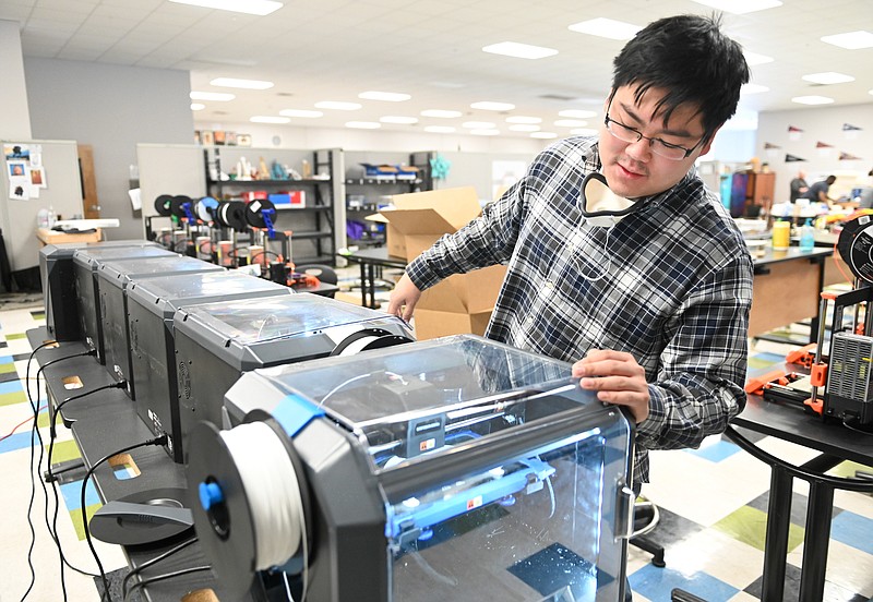 Contributed Photo by Angela Lewis Foster / UTC graduate Chantz Yanagida monitors a 3D printer at Hamilton County's STEM School at Chattanooga State Community College. Yanagida is using the printers to create transparent face shields for health-care workers.