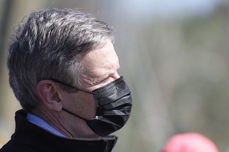 Tennessee Gov. Bill Lee wears a face mask as he visits an area hit by tornadoes on Tuesday, April 14, 2020, in Chattanooga, Tenn. Tornadoes went through the area Sunday, April 12. (AP Photo/Mark Humphrey)