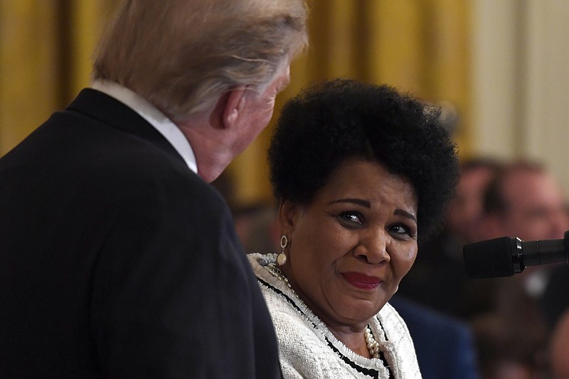 FILE - In this April 1, 2019, file photo President Donald Trump, left, listens as former prisoner Alice Marie Johnson, right, speaks at the 2019 Prison Reform Summit and First Step Act Celebration in the East Room of the White House in Washington. The 64-year-old African American great-grandmother spent 21 years in prison for a nonviolent drug offense before Trump commuted her sentence in 2018. (AP Photo/Susan Walsh, File)


