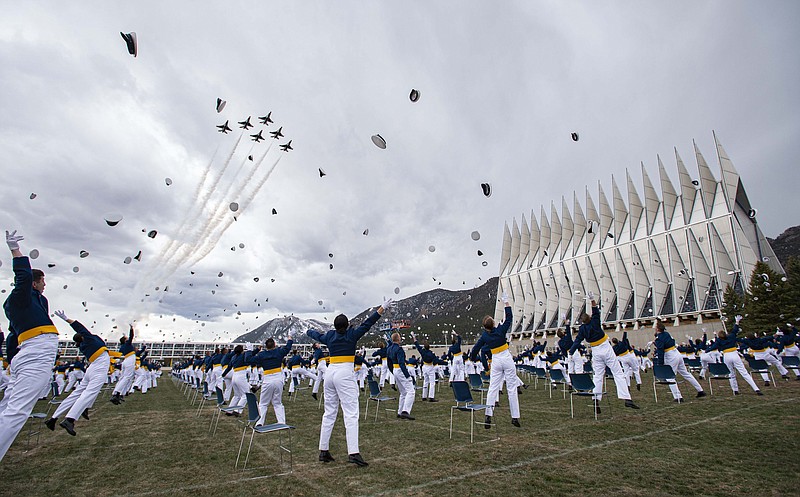 The class of 2020 toss their caps into the air as the Thunderbirds fly over Saturday, April 18, 2020, at the conclusion of the Air Force Academy graduation in Colorado Springs, Colo. Nearly 1,000 cadets graduated in a scaled-down ceremony due to the coronavirus pandemic. Saturday's commencement was attended by Vice President Mike Pence and capped a difficult final semester in which the cadets attended virtual classes and ate their meals alone in dorm rooms. (Christian Murdock/The Gazette via AP)


