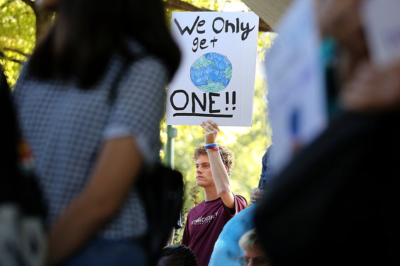 Staff photo by Erin O. Smith / Clay Couch holds up a sign reading "we only get one!" during a Climate Strike Friday, Sept. 20, 2019 in front of the Tennessee Aquarium in Chattanooga, Tennessee. The event coincides with Global Climate Strike Week.