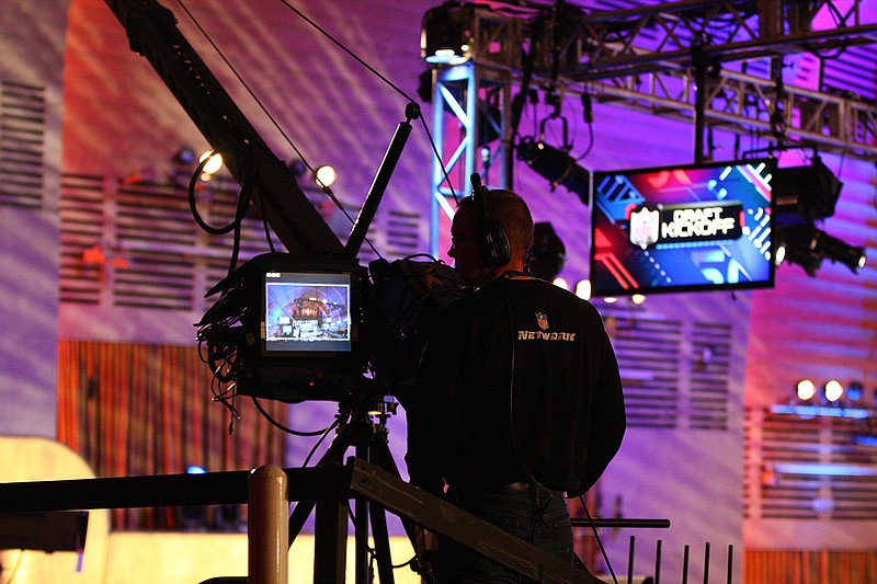 AP photo by Nat Castaneda / NFL Network employees work during the 2013 draft at Radio City Music Hall in New York. The 2020 draft that starts Thursday will be unlike any other, taking place remotely after originally being scheduled for Las Vegas before the COVID-19 pandemic scrapped that plan.