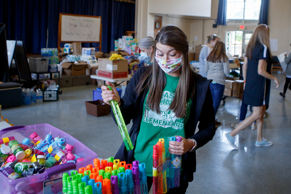 Staff photo by C.B. Schmelter / East Brainerd Elementary second grade teacher Kacie Pendergrass helps organize items while talking to the Times Free Press in the auditorium at Chattanooga School for the Liberal Arts on Monday, April 20, 2020 in Chattanooga, Tenn. Teachers and volunteers made care packages for 250 East Brainerd Elementary students who were displaced by Easter Sunday's tornado. The packages included school materials but also items like Play-Doh, colored pencils and books.