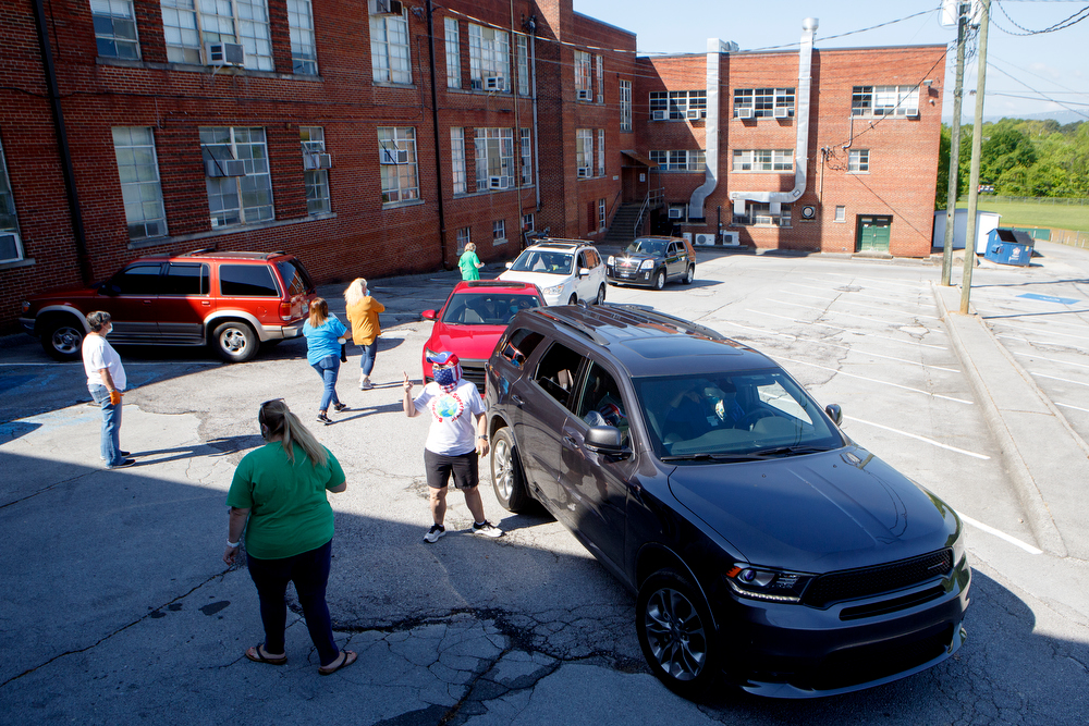 Staff photo by C.B. Schmelter / Cars line up to pick up care packages at Chattanooga School for the Liberal Arts on Tuesday, April 21, 2020 in Chattanooga, Tenn. Teachers and volunteers made care packages for 250 East Brainerd Elementary students who were displaced by Easter Sunday's tornado. The packages included school materials but also items like Play-Doh, colored pencils and books.