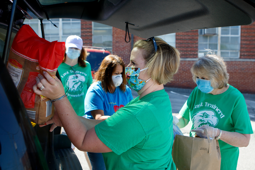 Staff photo by C.B. Schmelter / Ashley Ford, a first grade teacher at East Brainerd Elementary, loads supplies into a car at Chattanooga School for the Liberal Arts on Tuesday, April 21, 2020 in Chattanooga, Tenn. Teachers and volunteers made care packages for 250 East Brainerd Elementary students who were displaced by Easter Sunday's tornado. The packages included school materials but also items like Play-Doh, colored pencils and books.