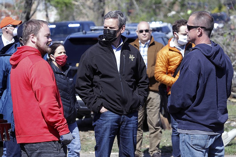 Tennessee Gov. Bill Lee, center, talks with residents as he visits a storm-damaged area Tuesday, April 14, 2020, in Chattanooga, Tenn. Tornadoes went through the area Sunday, April 12. (AP Photo/Mark Humphrey)