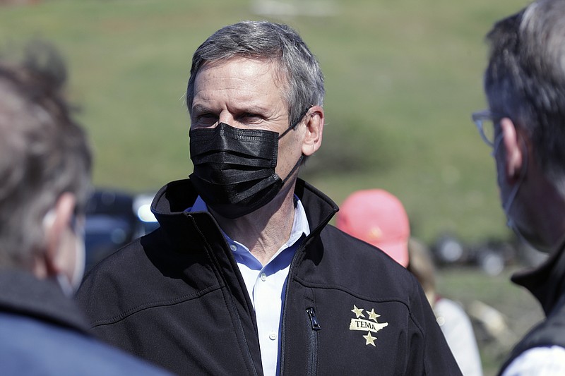 Tennessee Gov. Bill Lee, center, visits a storm-damaged area Tuesday, April 14, 2020, in Chattanooga, Tenn. Tornadoes went through the area Sunday, April 12. (AP Photo/Mark Humphrey)


