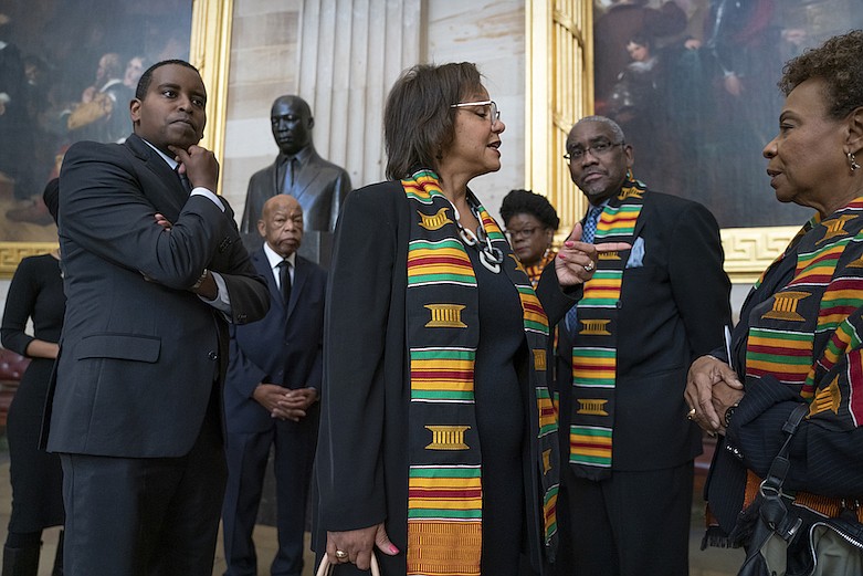 In this Oct. 24, 2019, file photo members of the Congressional Black Caucus gather for a memorial ceremony for the late Maryland Rep. Elijah Cummings, at the Capitol in Washington. From left are Rep. Joe Neguse, D-Colo., Rep. John Lewis, D-Ga., Rep. Robin Kelly, D-Ill., Rep. Gwen Moore, D-Wis., Rep. Gregory Meeks, D-N.Y., and Rep. Barbara Lee, D-Calif. The Congressional Black Caucus PAC is endorsing Joe Biden's presidential bid, further cementing his support among the nation's influential black political leadership. Black voters have long anchored the former vice president's White House bid with decisive wins in South Carolina and on Super Tuesday. The chairman of the Congressional Black Caucus political action committee is New York congressman Gregory Meeks, who tells The Associated Press there's "no question" Biden is the right person to lead the country.(AP Photo/J. Scott Applewhite, File)