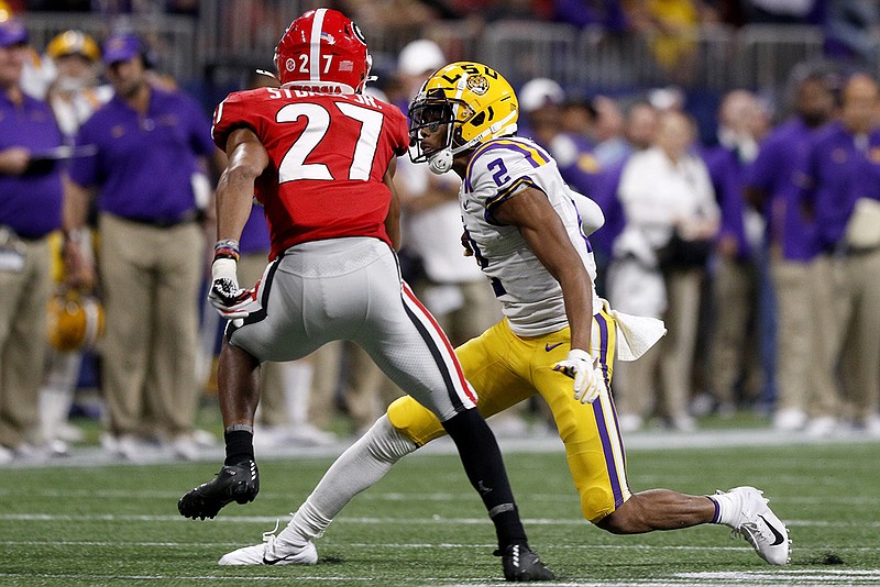 Staff photo by C.B. Schmelter / LSU wide receiver Justin Jefferson (2) makes a move to get past Georgia defensive back Eric Stokes during the SEC championship game on Dec. 7, 2019, at Atlanta's Mercedes-Benz Stadium. Jefferson is one of five former LSU players both CBS and NBC have projected as first-round draft picks.