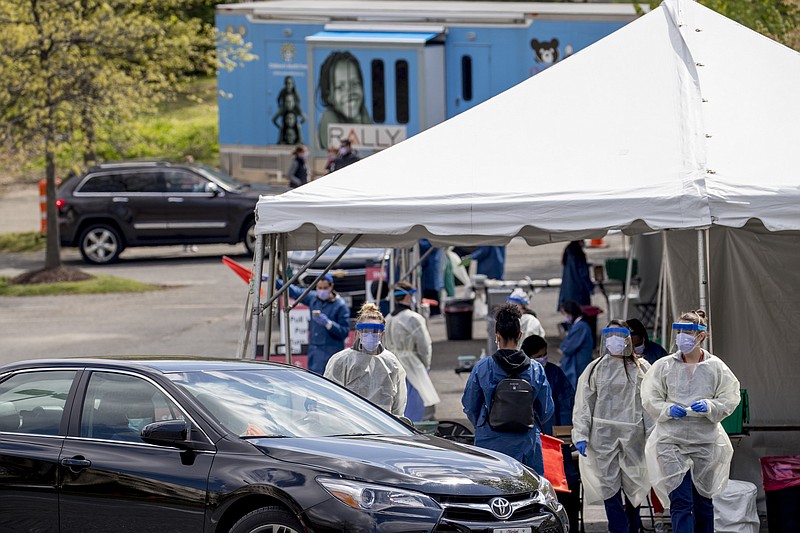 Children's National Hospital tests children and young adults for COVID-19 at a drive-through (drive-in) testing site at Trinity University, Thursday, April 16, 2020, in Washington. (AP Photo/Andrew Harnik)