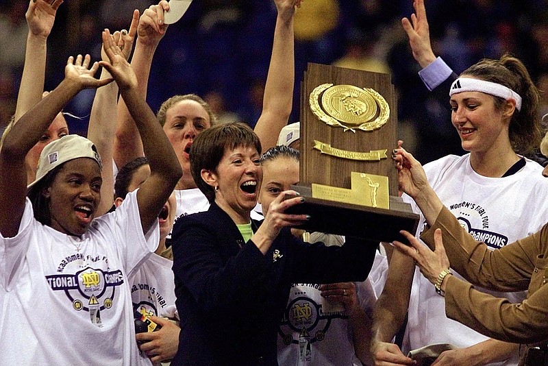 AP photo by Michael Conroy / Notre Dame women's basketball coach Muffet McGraw holds up the national championship trophy after Notre Dame beat Purdue in the NCAA tournament final on April 1, 2001, in St. Louis.