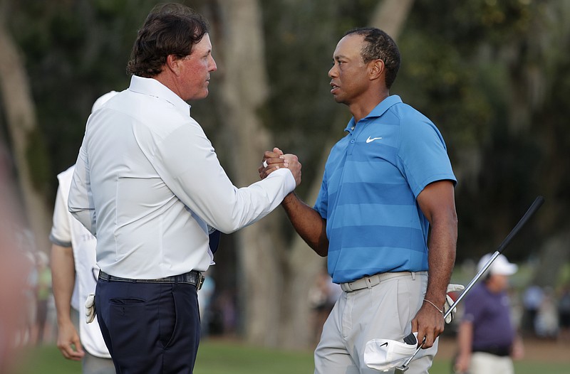 AP photo by Lynne Sladky / Phil Mickelson, left, and Tiger Woods shake hands after the first round of The Players Championship on May 20, 2018, in Ponte Vedra Beach, Fla.