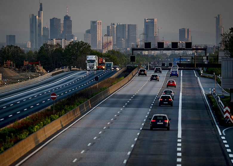 In this April 16, 2020, a few cars and trucks drive on the usually very crowded main highway around Frankfurt, Germany, that is seen in the background. As the restrictions to avoid the spreading of the coronavirus are eased, Chancellor Angela Merkel has pointed to South Korea as an example of how Germany will have to improve measures to "get ahead" of the pandemic with more testing and tracking of cases so that the rate of infections can be slowed. (AP Photo/Michael Probst)