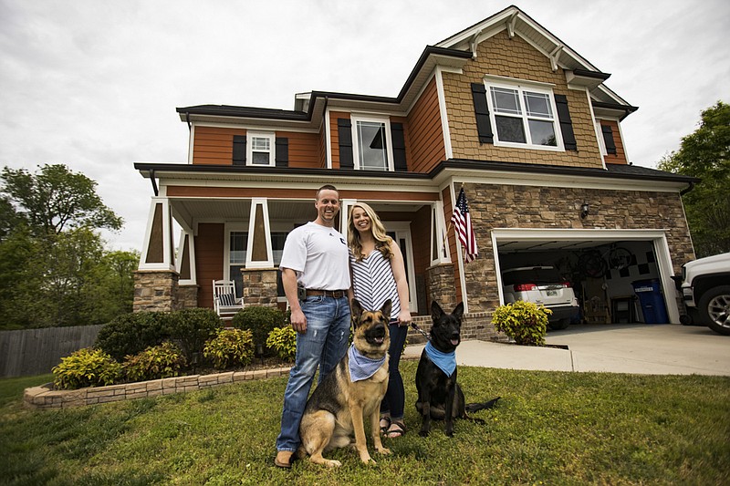 Staff photo by Troy Stolt / Nathan and Hannah Barger stand for a portrait with their dogs in front of their home on Bayonet Lane on Wednesday, April 22, 2020 in Hixson, Tenn.