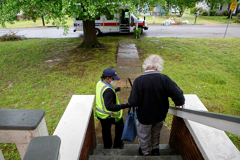 Staff photo by C.B. Schmelter / Gary Shimel, right, gets help from CARTA Care-A-Van driver Alicia Beck down the steps at his home on Thursday, April 23, 2020 in Chattanooga, Tenn. While Kristi Wick, the Vicki B. Gregg chair of gerontology at the University of Tennessee at Chattanooga, said that CARTA has done a great job of providing transportation, it remains an issue for the 25% of older adults in Hamilton County who don't have cars.