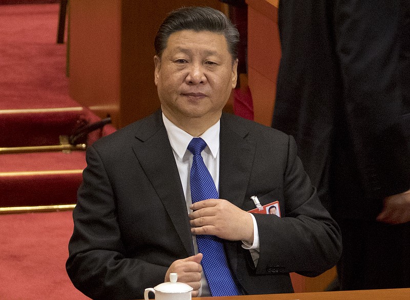 FILE - In this file photo taken Monday, March 19, 2018, Chinese President Xi Jinping attends a plenary session of China's National People's Congress (NPC) at the Great Hall of the People in Beijing. Chinese envoys have set off diplomatic firestorms with a combative defense whenever their country is accused of not acting quickly enough to stem the spread of the coronavirus pandemic. Xi's government has urged its diplomats to pursue "major-country diplomacy with Chinese characteristics" _ a call for China to reassert its historic status as a global power. (AP Photo/Mark Schiefelbein, File)


