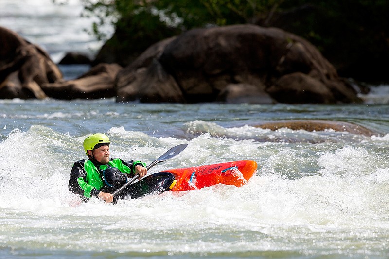 Staff photo by C.B. Schmelter / Todd Harrison works a rapid on the Middle Ocoee River on Saturday, April 25, 2020 in Polk County, Tenn. The TVA had temporarily halted recreational whitewater releases on April 4 due to COVID-19 but began releases again this weekend. The river is open to private boaters.