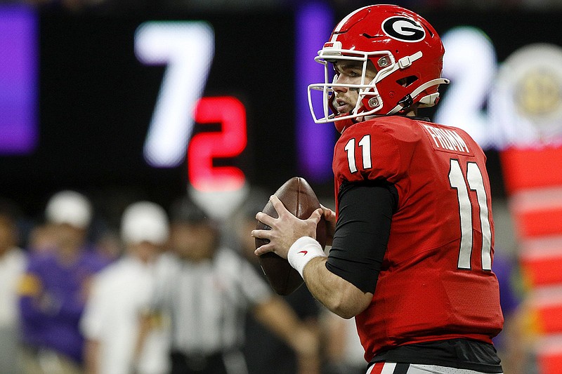Staff photo by C.B. Schmelter / Georgia junior quarterback Jake Fromm looks for a receiver during the 2019 SEC championship game against LSU in December at Mercedes-Benz Stadium in Atlanta.