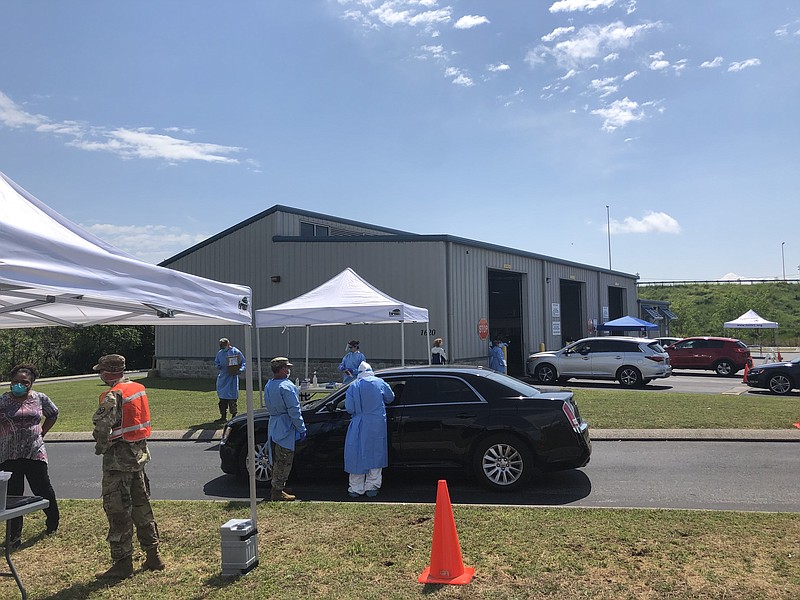 Photo by Patrick Filbin / Tennessee health officials and National Guard members work at the Hamilton county COVID-19 testing site on Saturday afternoon.
