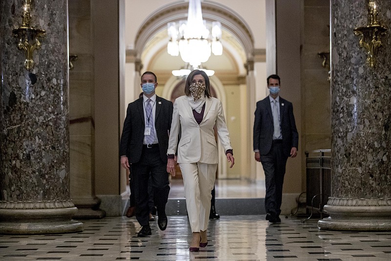 FILE - In this April 23, 2020, file photo House Speaker Nancy Pelosi of Calif., walks to her office after signing the Paycheck Protection Program and Health Care Enhancement Act, H.R. 266, after it passed the House on Capitol Hill in Washington. Pelosi shelved a proposal for proxy voting this week after Republicans objected. (AP Photo/Andrew Harnik, File)


